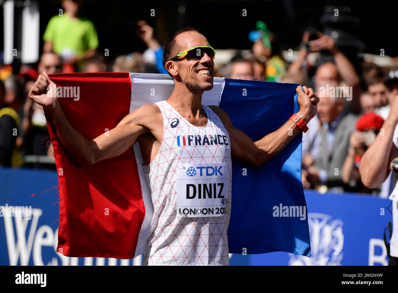 Yohann Diniz of France celebrating winning gold in the IAAF World Athletics Championships 50k walk in The Mall, London. French flag Stock Photo