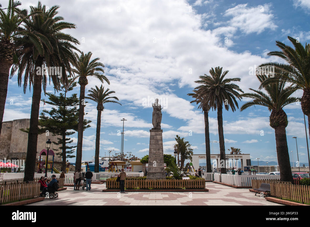 clouds, palm trees and the statue of Guzman El Bueno, Spanish nobleman and hero of Spain during the medieval period in the town of Tarifa Stock Photo