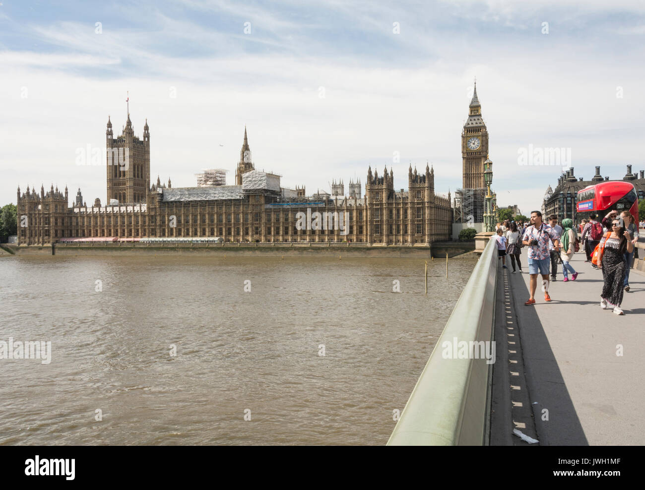 Pedestrians on Westminster Bridge outside the Houses of Parliament on