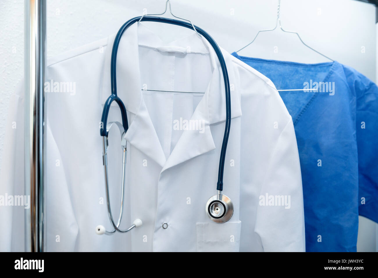 medical occupation uniforms on hanger Stock Photo