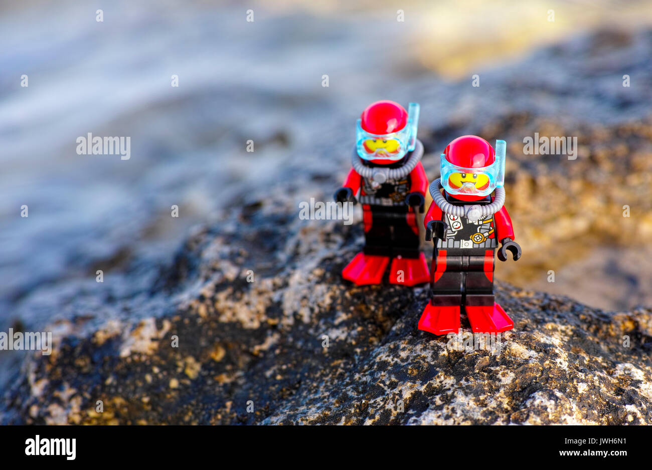 Paphos, Cyprus - October 09, 2016 Two Lego scuba divers minifigures standing on sea rock. Stock Photo