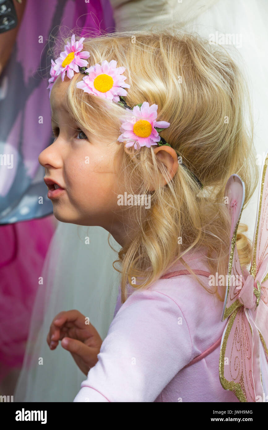 Burley, Hampshire, UK. 12th Aug, 2017. New Forest Fairy Festival. Masses of fairies sprinkled with fairy dust, descend on Burley for the weekend for a magical enchanting festival in the New Forest. Young girl dressed as fairy wearing flowery hairband. Credit: Carolyn Jenkins/Alamy Live News Stock Photo