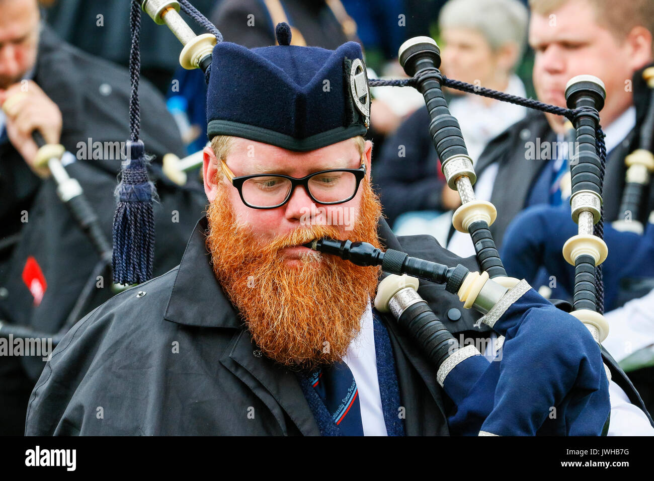 Glasgow, UK. 12th Aug, 2017. It was estimated that more than 10,000 spectators turned out to watch the final day of "Piping Live" and the World Pipe Band Championships, an Internationally renowned competition, take place in Glasgow Green as the finale to a week of entertainment and free concerts that have taken place around Glasgow city centre. Despite the occasional heavy rain shower, play continued and spirits weren't dampened. Credit: Findlay/Alamy Live News Stock Photo
