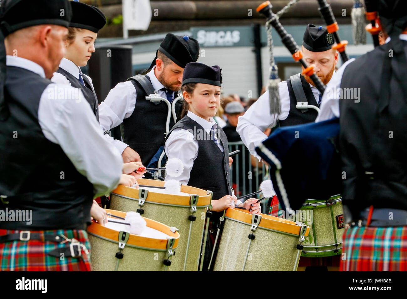 Glasgow, UK. 12th Aug, 2017. It was estimated that more than 10,000 spectators turned out to watch the final day of "Piping Live" and the World Pipe Band Championships, an Internationally reknowned competition, take place in Glasgow Green as the finale to a week of entertainment and free concerts that have taken place around Glasgow city centre. Despite the occasional heavy rain shower, play continued and spirits weren't dampened. Credit: Findlay/Alamy Live News Stock Photo
