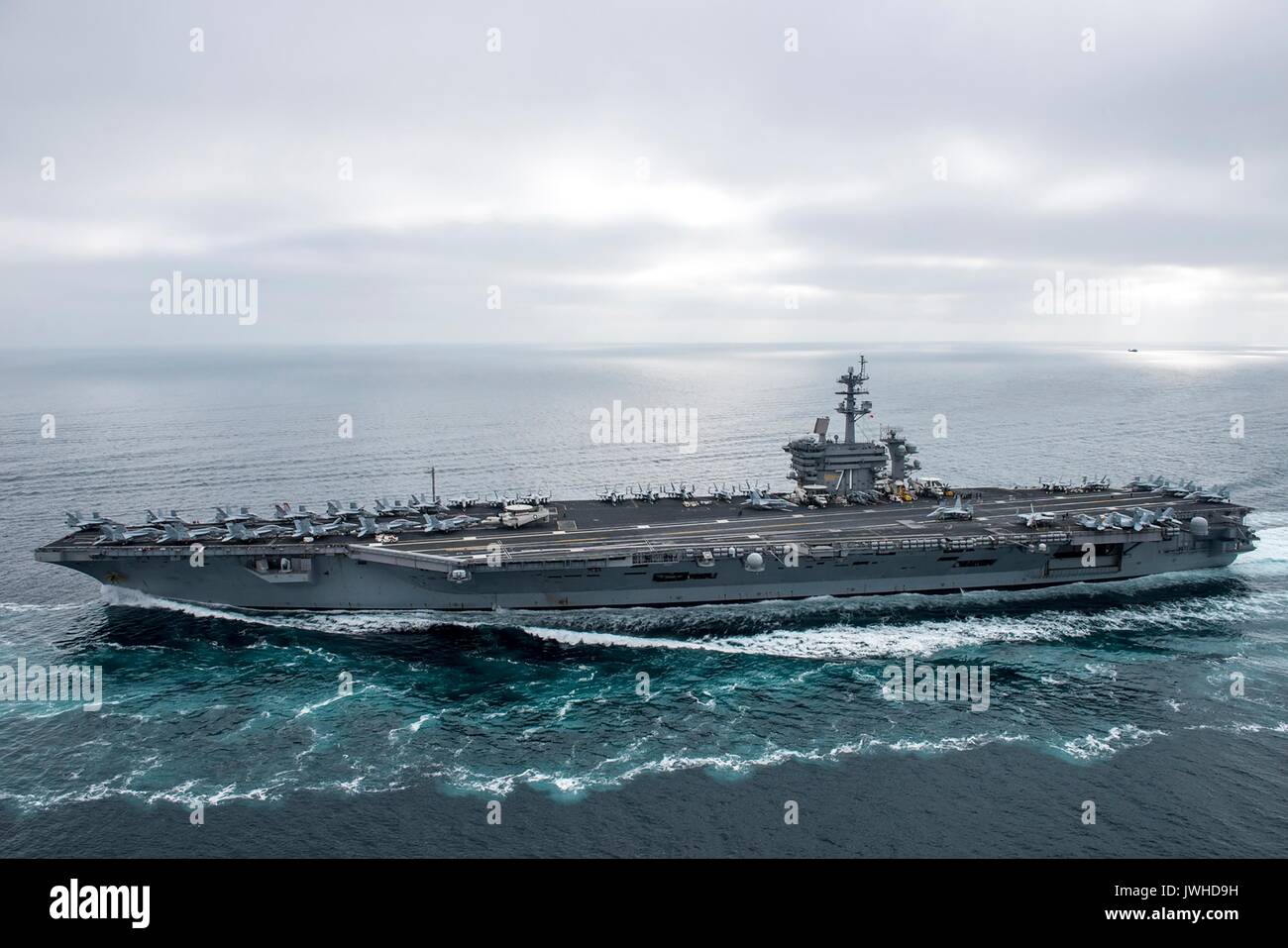 Pacific Ocean. 11th Aug, 2017. The U.S. Navy Nimitz-class nuclear aircraft carrier USS Theodore Roosevelt during a strait transit show of force exercise with the Theodore Roosevelt Carrier Strike Group August 11, 2017 in the Pacific Ocean. The training takes place during elevated tension with North Korea. Credit: Planetpix/Alamy Live News Stock Photo