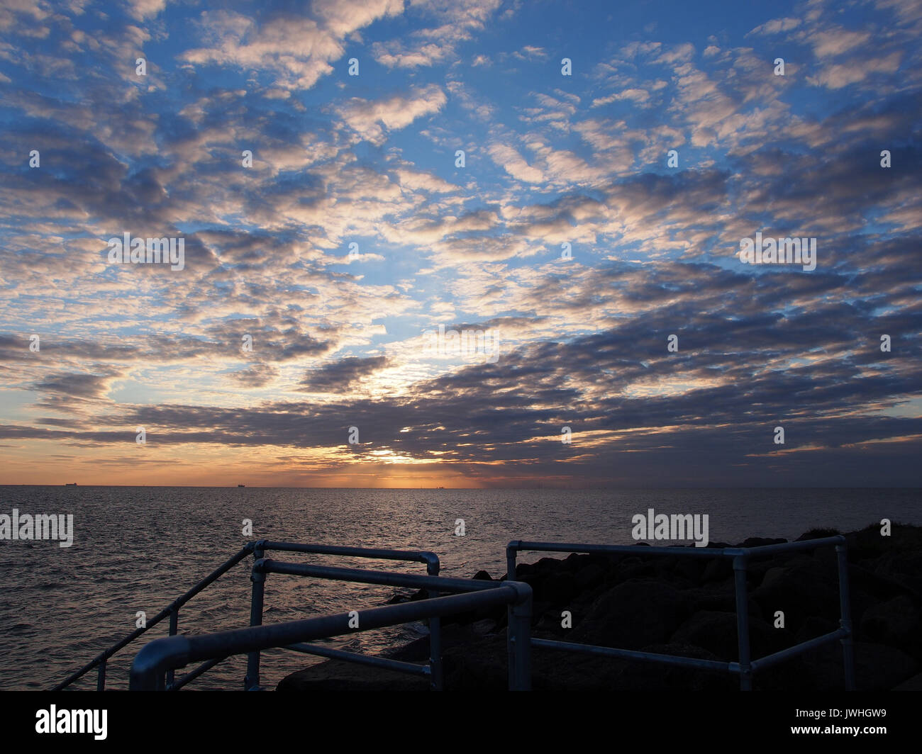 Sheerness, Kent. 13 Aug, 2017. UK Weather: a red sky in the morning ('Shepherd's warning') as the sun broke through cloud cover. Credit: James Bell/Alamy Live News Stock Photo