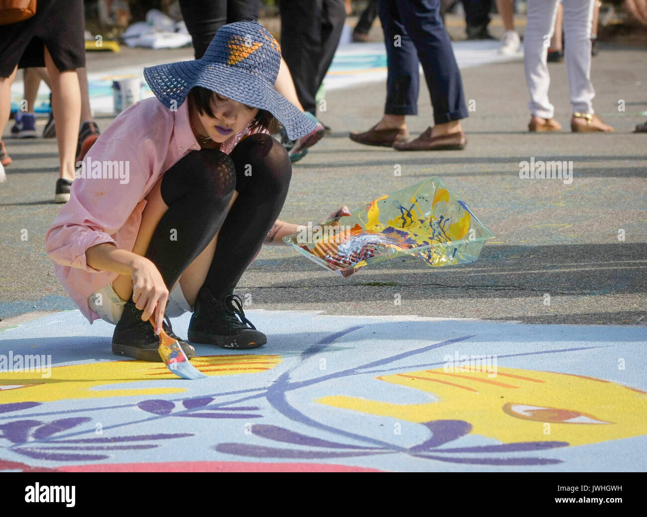 Vancouver, Canada. 12th Aug, 2017. An artist paints on the ground