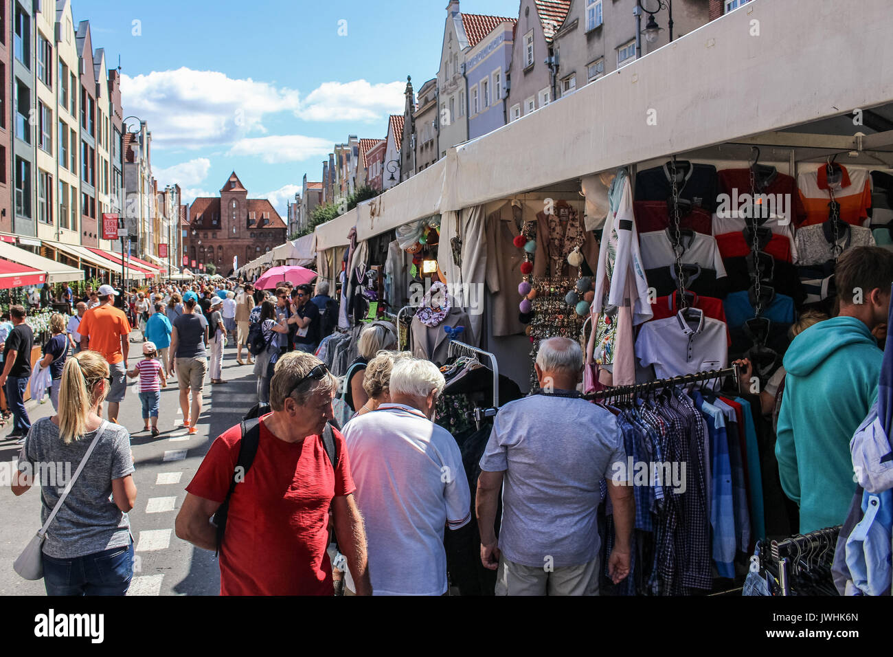 Gdansk, Poland. 13th August, 2017. People looking for goods at a flea market during 757th edition of St. Dominic’s Fair are seen in Gdansk, Poland on 13 August 2017  More than one thousand 1000 traders, artists and collectors participate in the Fair occupying with their stands several streets in the centre of the in the historical city centre. St. Dominic’s Fair is the largest open-air trade and cultural event in Poland and one of the largest such events in Europe. It has enjoyed over seven hundred fifty years of tradition; it was established by the Pope Alexander IV in 1260. Stock Photo