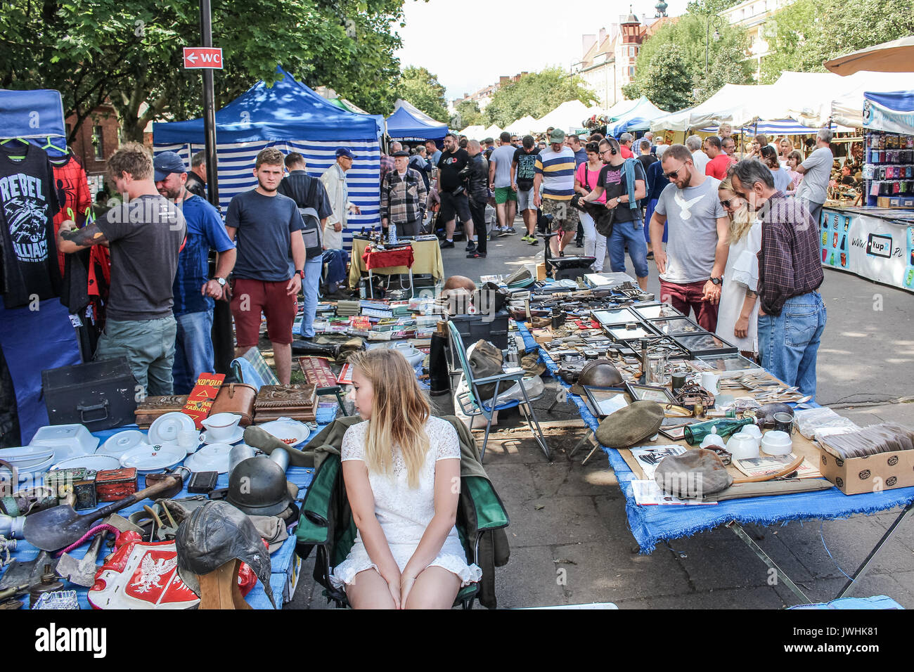 Gdansk, Poland. 13th August, 2017. People looking for goods at a flea market during 757th edition of St. Dominic’s Fair are seen in Gdansk, Poland on 13 August 2017  More than one thousand 1000 traders, artists and collectors participate in the Fair occupying with their stands several streets in the centre of the in the historical city centre. St. Dominic’s Fair is the largest open-air trade and cultural event in Poland and one of the largest such events in Europe. It has enjoyed over seven hundred fifty years of tradition; it was established by the Pope Alexander IV in 1260. Stock Photo