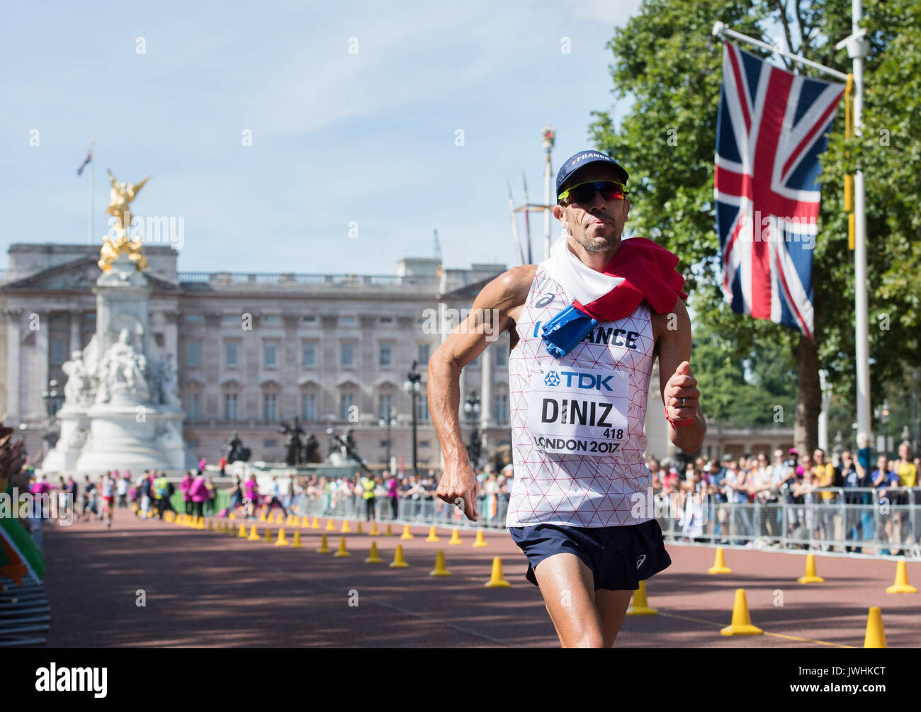 London, UK. 13th Aug, 2017. French athlete Yohann Diniz wears a French flag around his neck as he nears the finish line after competing in the 50 kilometre marathon at the IAAF London 2017 World Athletics Championships in London, United Kingdom, 13 August 2017. Photo: Rainer Jensen/dpa/Alamy Live News Stock Photo