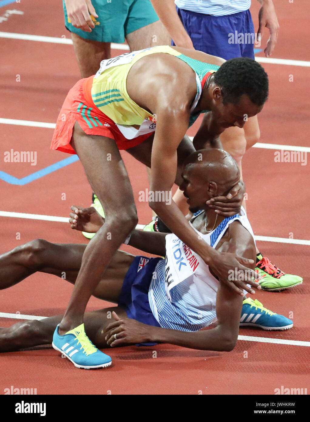 London, UK. 12th Aug, 2017.  Muktar Edris, Ethiopia, winner, helps Mo Farah, Great Britain, up after beating Farah to gold in the men's 5000m final on day nine of the IAAF London 2017 world Championships at the London Stadium. Credit: Paul Davey/Alamy Live News Stock Photo