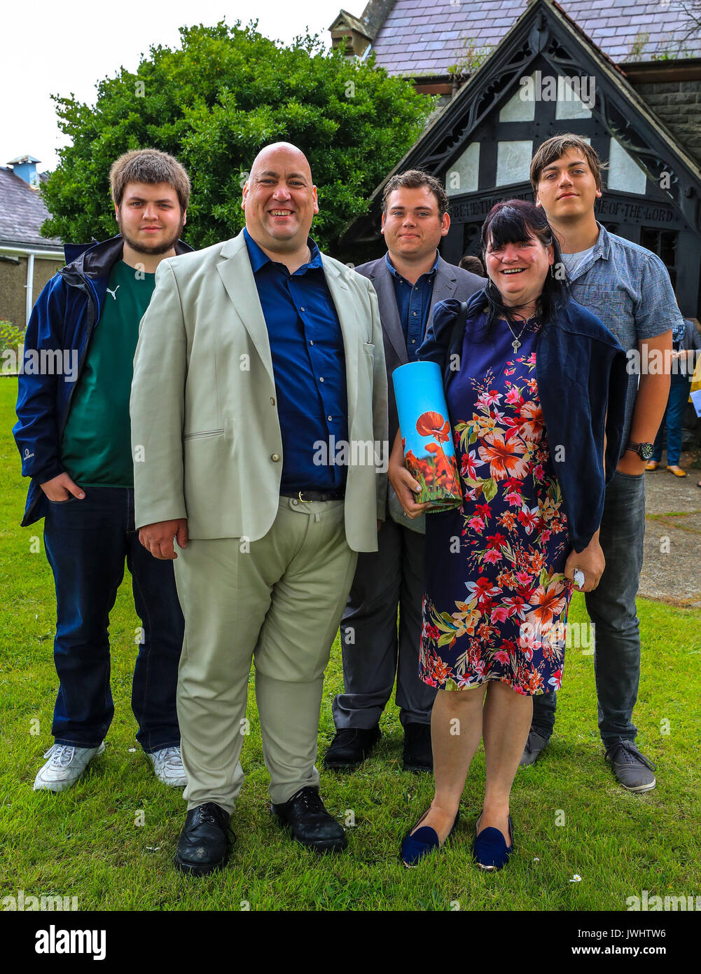Jill Saward's sister Sue Lancaster, holding a container with the ashes of the victims' rights campaigner, with Jill's husband Gavin and sons Myles, Fergus and Rory outside the church of St David's in Nefyn, north-west Wales, as a memorial service is held in her memory. Stock Photo