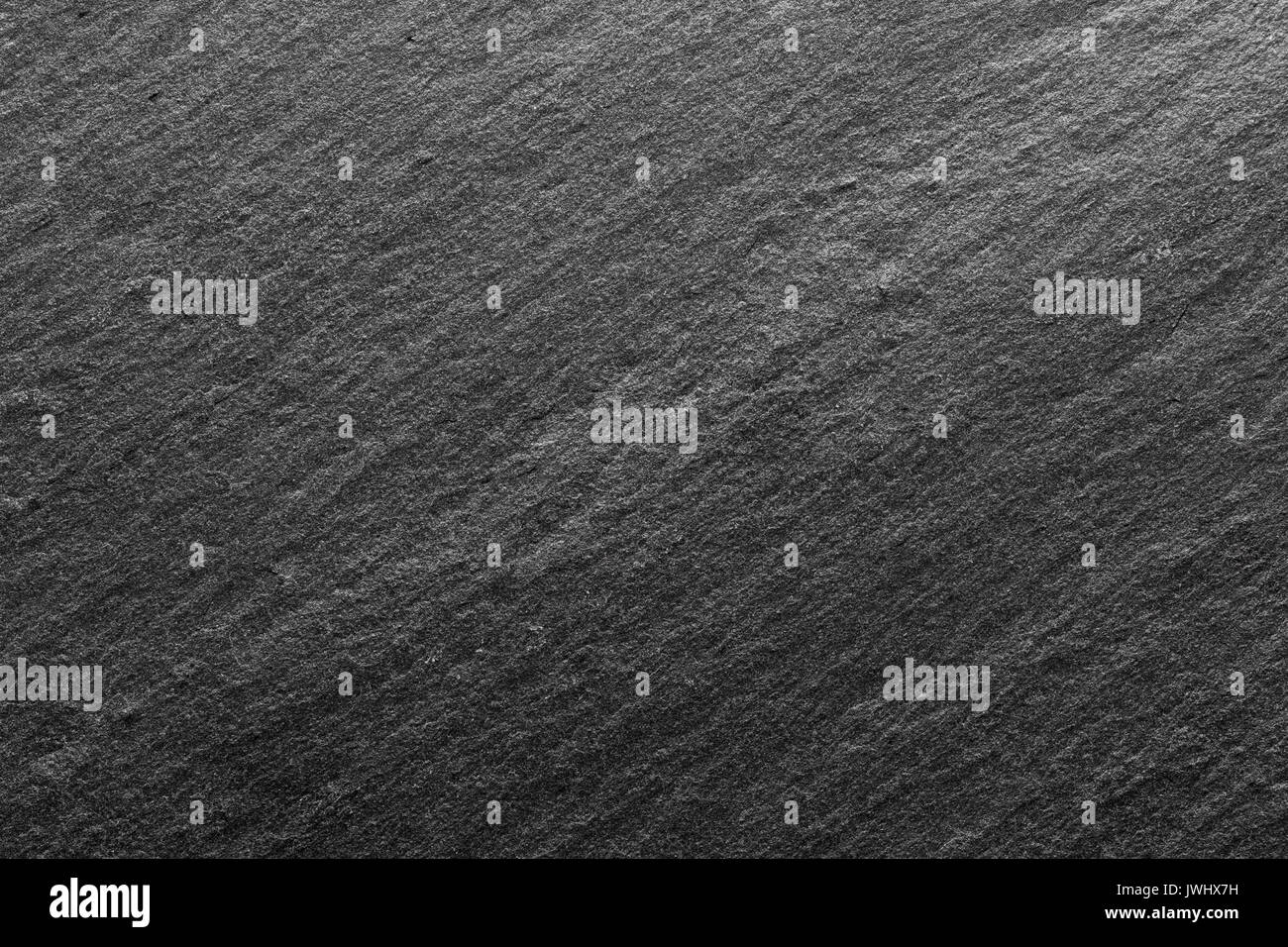 Black slate background or textured stony table close-up. Stock Photo