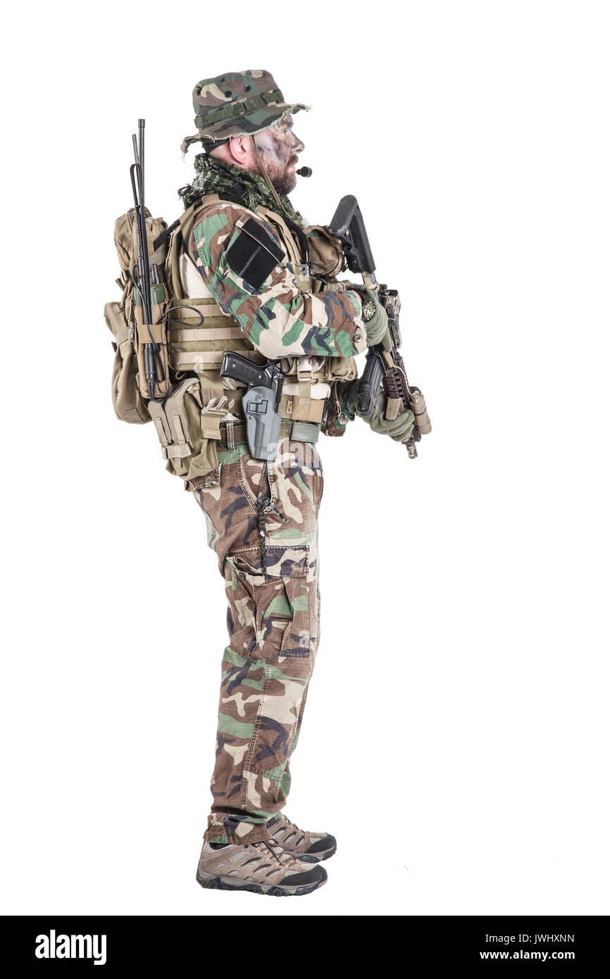 Special forces United States in Camouflage Uniforms studio shot. Holding weapons, wearing jungle hat, Shemagh scarf, painted face, his outfit clothes  Stock Photo