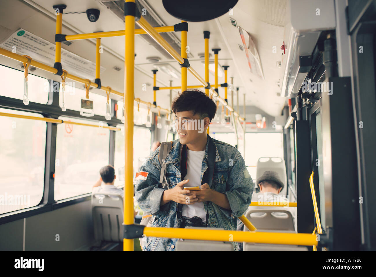 People in the bus. Asian man using smartphone in public transport Stock Photo