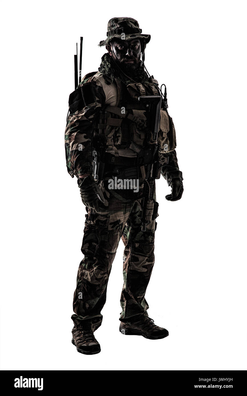 Special forces United States in Camouflage Uniforms studio shot. Holding weapons, wearing jungle hat, Shemagh scarf, painted face, his outfit clothes  Stock Photo