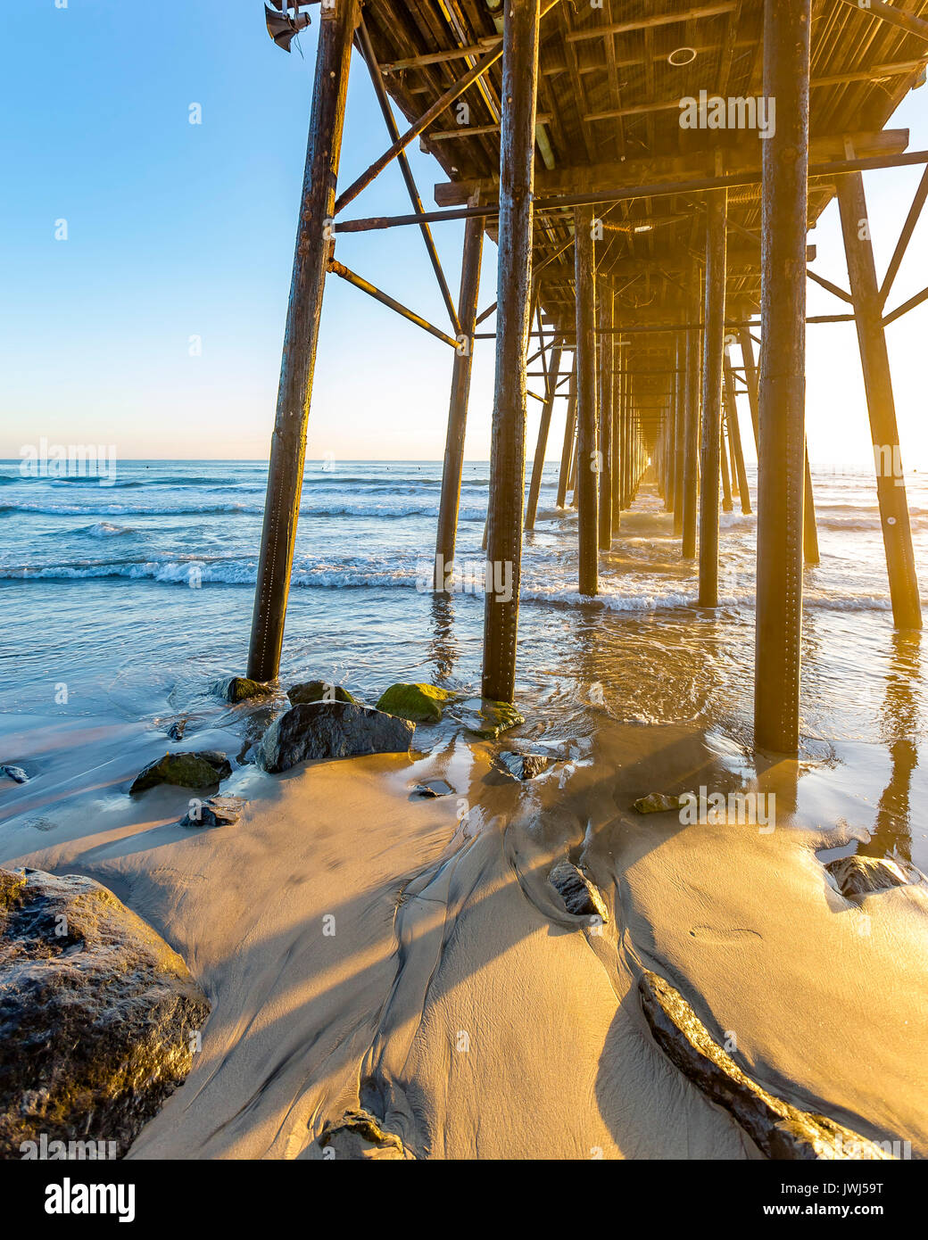 Sunset at the Oceanside pier in southern California. Sunset views under the  pier on the beach Stock Photo - Alamy