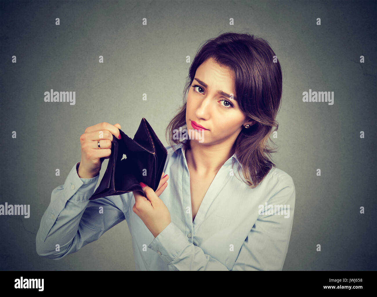 Woman with no money. Sad businesswoman holding empty wallet Stock Photo