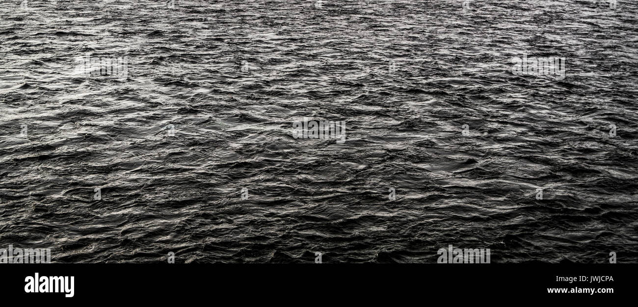 Abstract dark water surface. Dark grunge water background. Nature background. Gloomy background Stock Photo