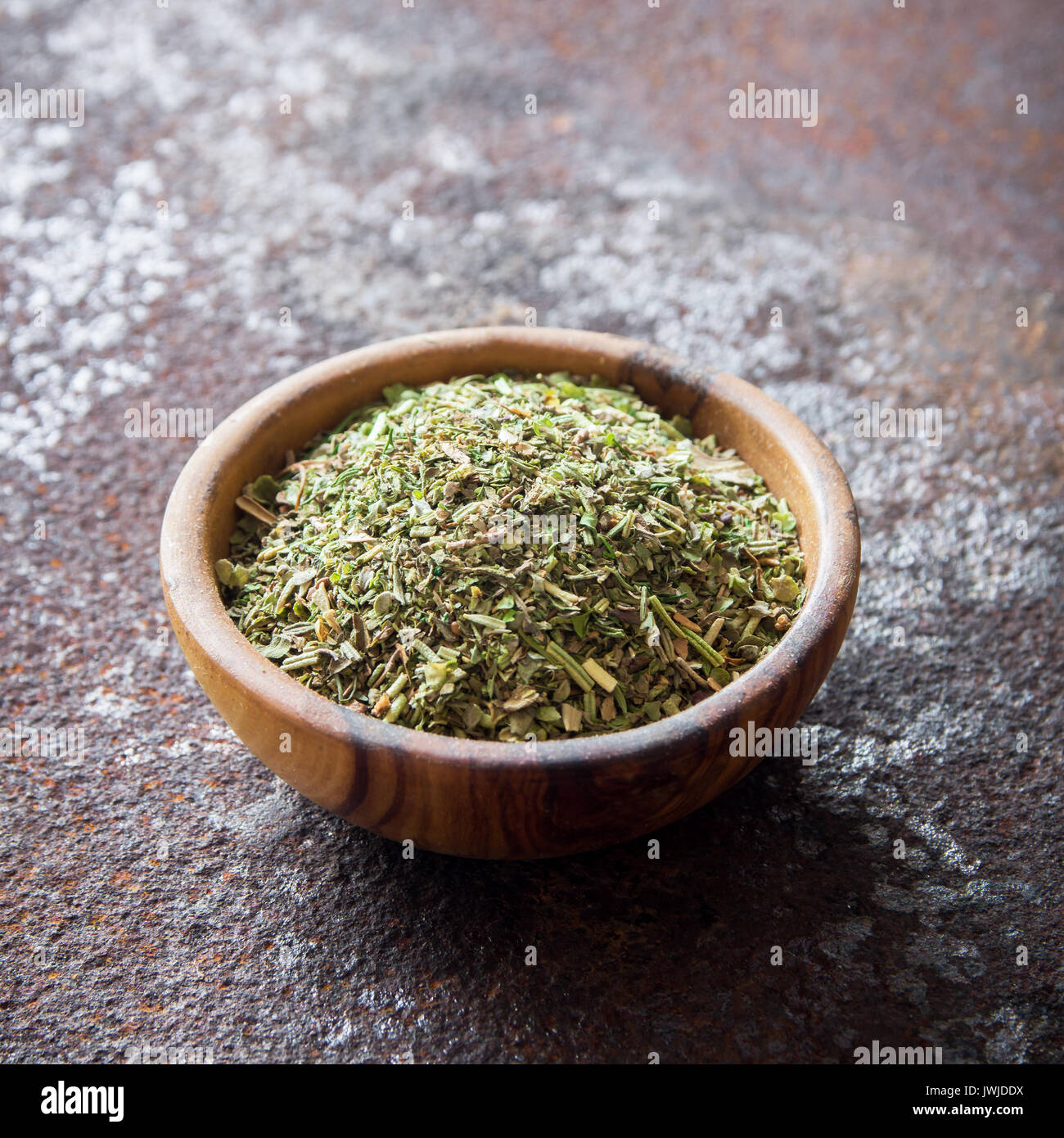 Mixed Italian Herbs Seasoning on rustic metal background, copy space