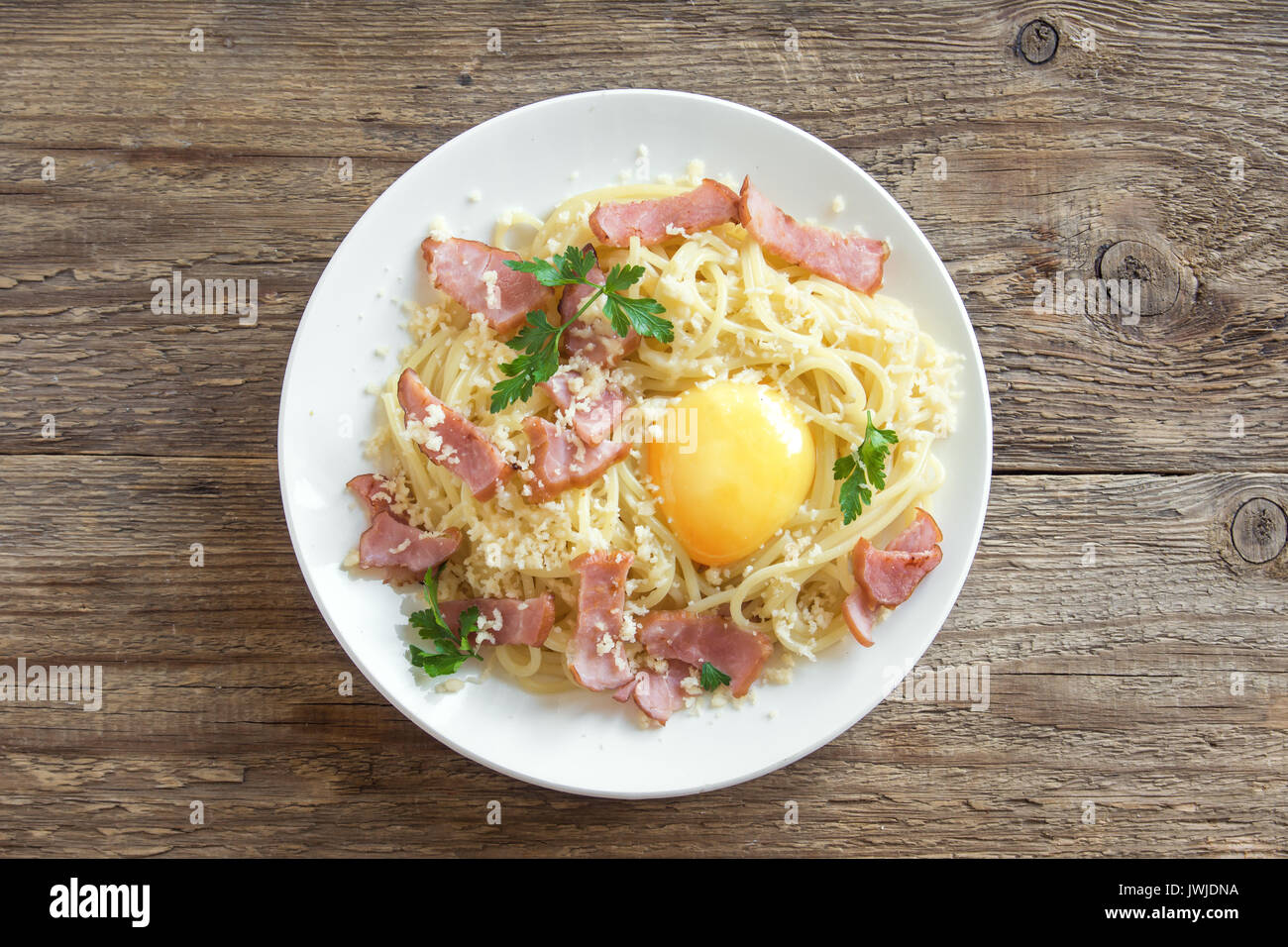 Spaghetti carbonara pasta with egg sauce, bacon and grated parmesan
