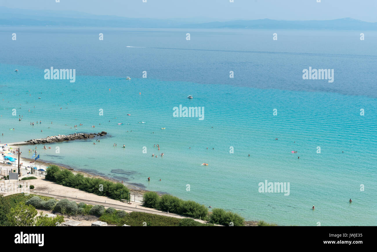 Chalkidiki, Greece- July 26 2017: Panoramic view of famous and idyllic beach of Kalithea with people swimming, resting and enjoying their summer vacat Stock Photo