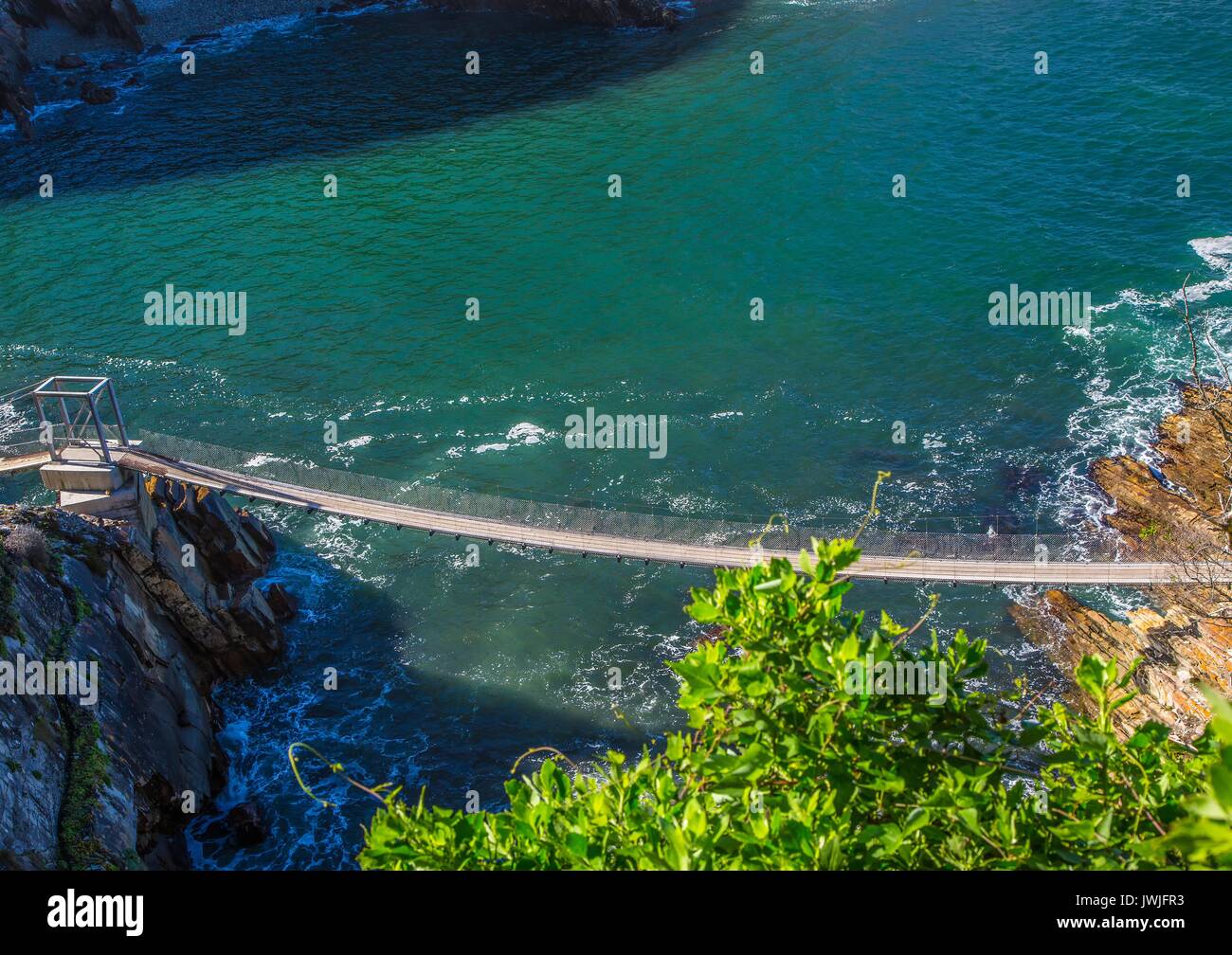 Famous bridge over Storms River Mouth at the Indian Ocean in South Africa Stock Photo