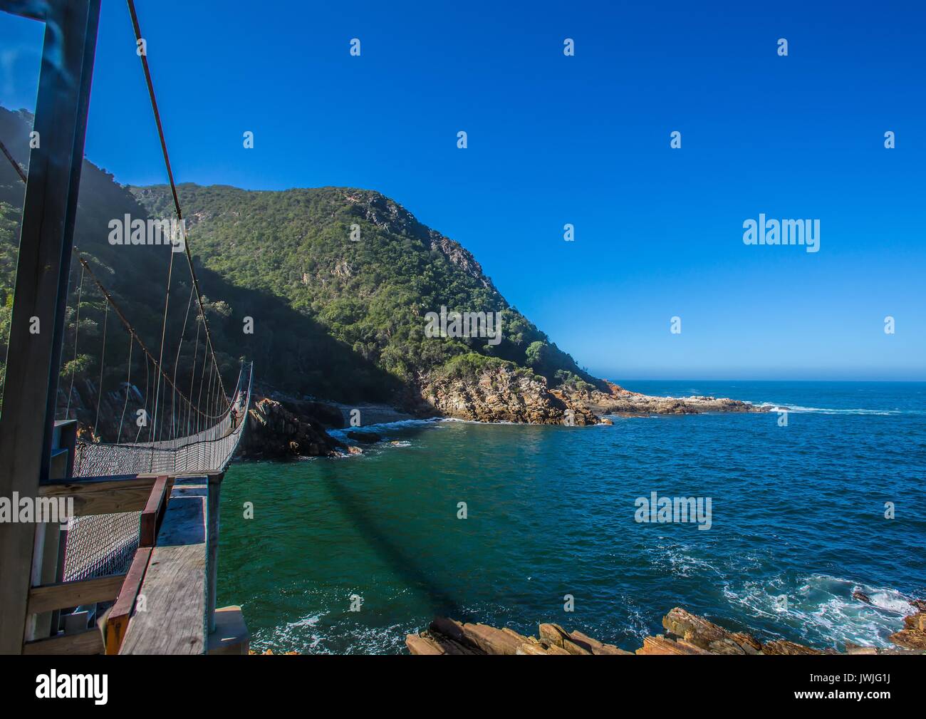 Famous bridge over Storms River Mouth at the Indian Ocean in South Africa Stock Photo