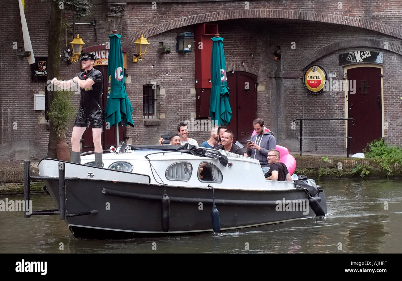 A boat carrying a stag party sails on a canal in Utrecht, the Netherlands, August 5, 2017. © John Voos Stock Photo