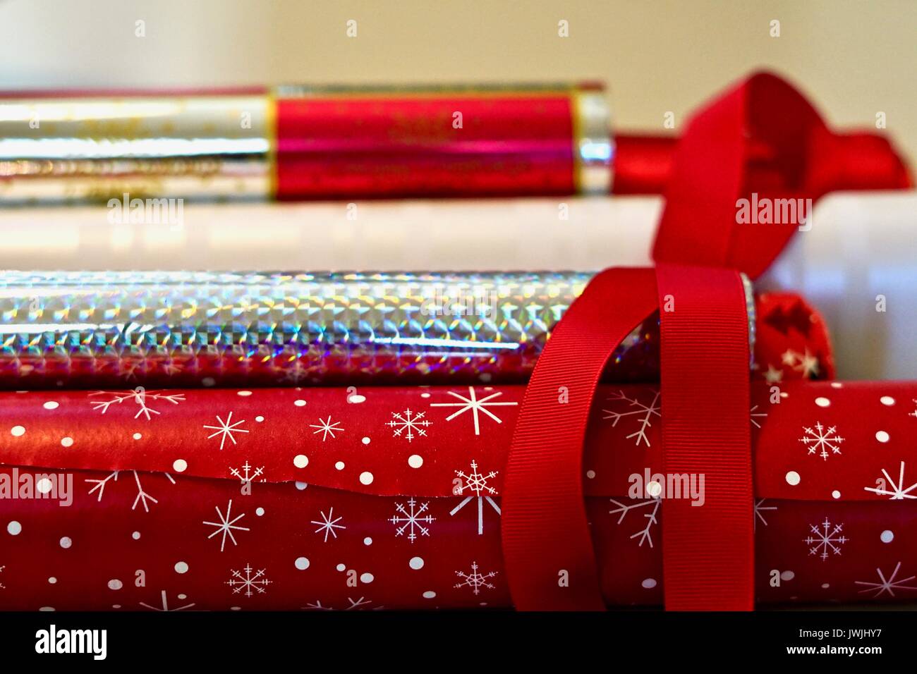 horizontal pile of red and silver wrapping paper rolls Stock Photo Alamy