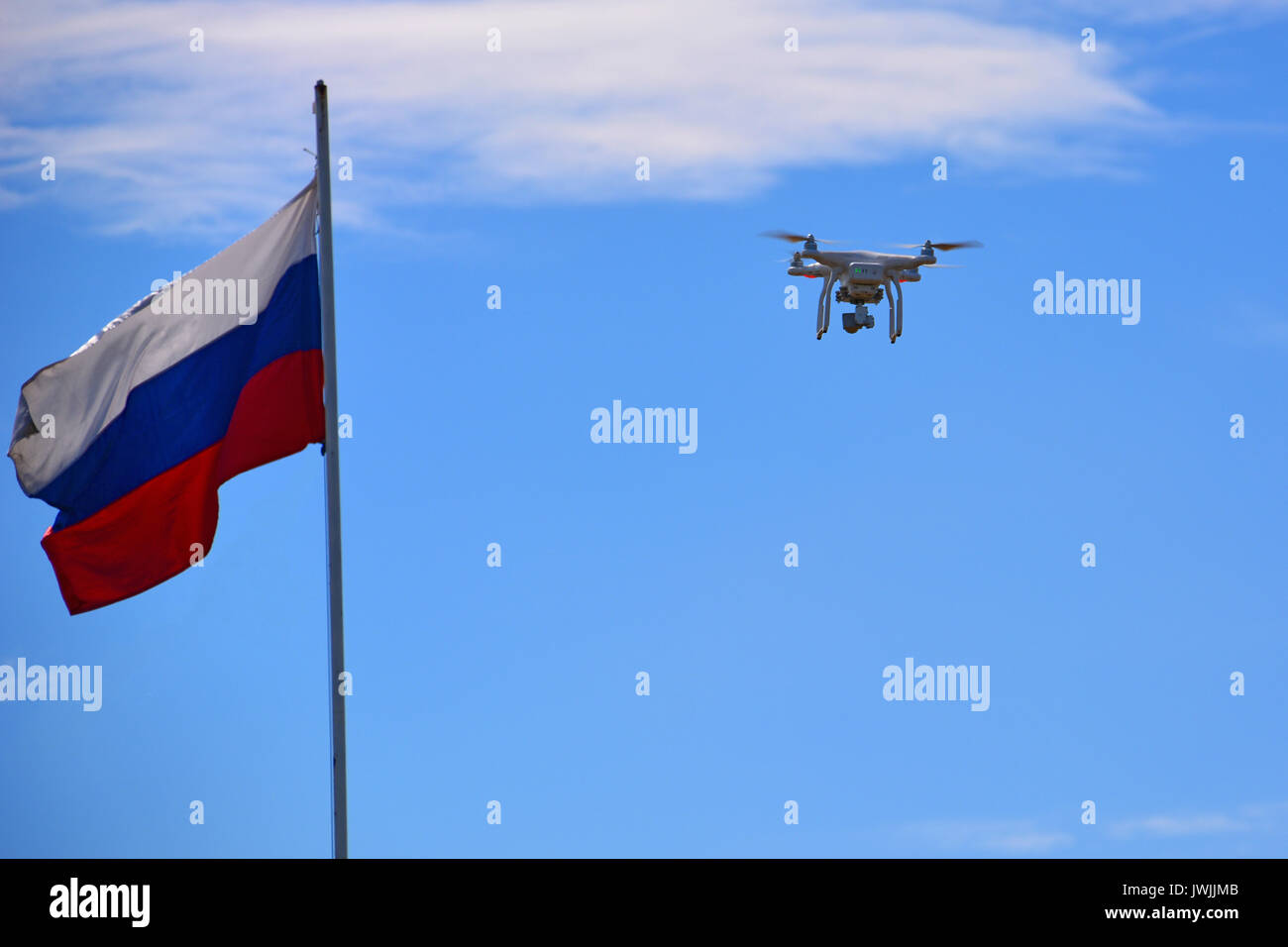 Flying drone with camera. Drone with digital camera flying over a Russia flag Stock Photo