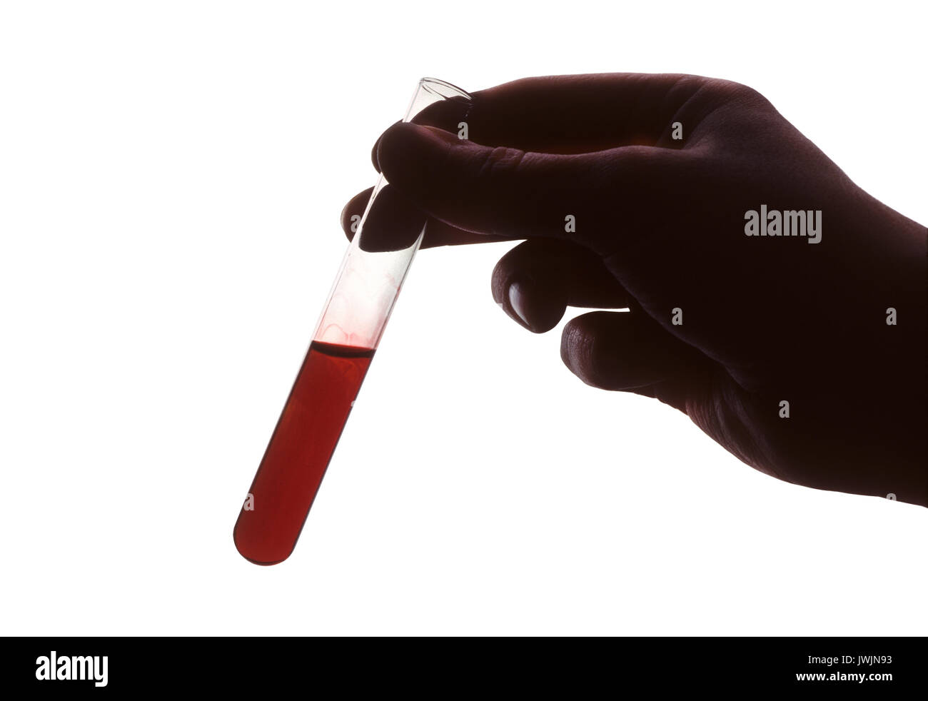 Hand holding test tube of red liquid against white background Stock ...