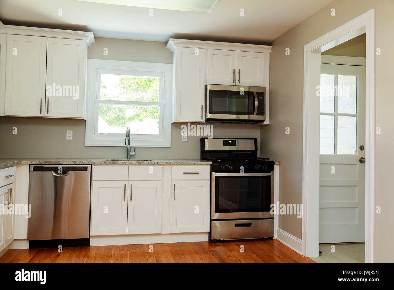 Gourmet Kitchen Features White Shaker Cabinets With Marble Stock