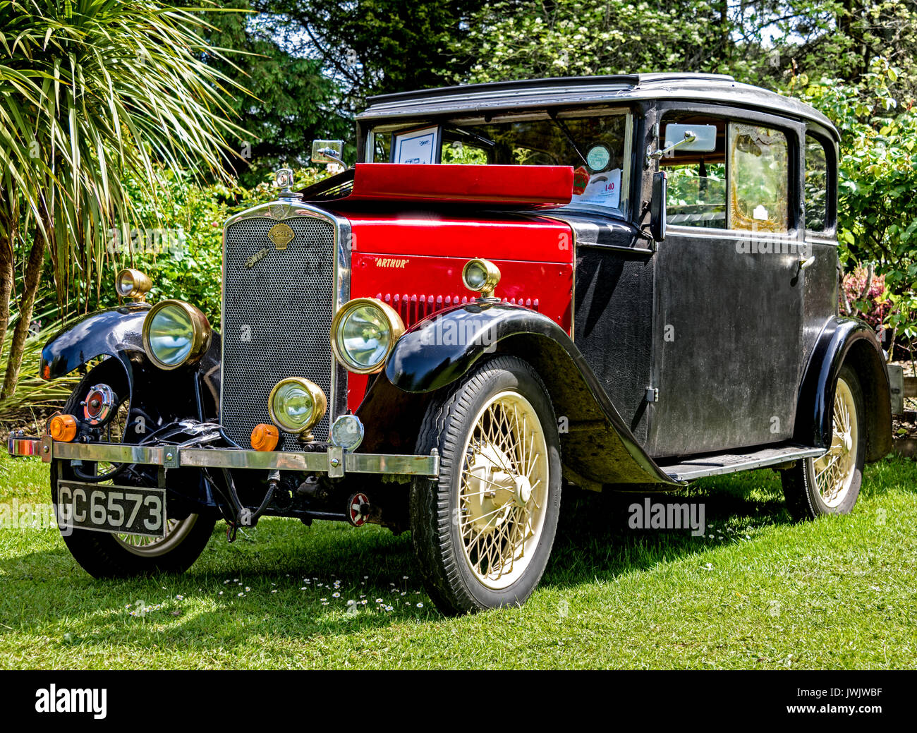Low-angle, front three quarter view of the 1929 Swift Foursome Coupe on display in a garden setting Stock Photo