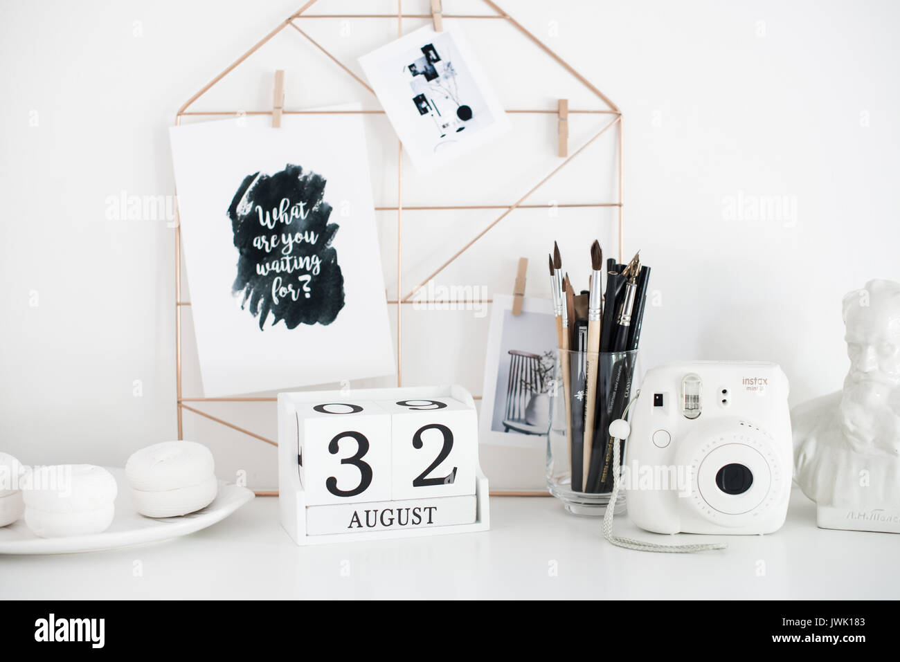 Stylish white desktop, home office interior details with camera Stock