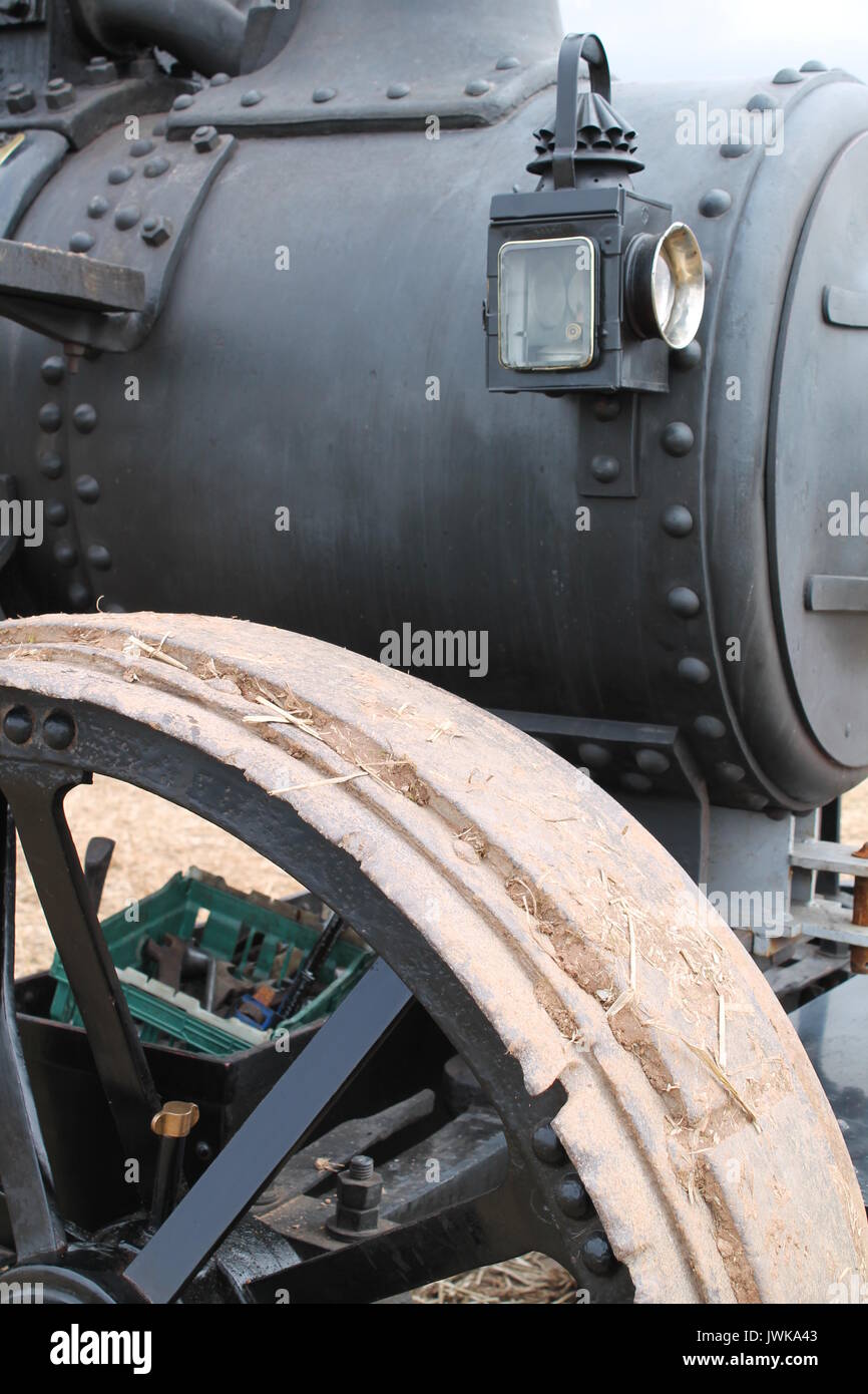 Vintage black steam traction engine with rivets, lamp and metal wheels ...