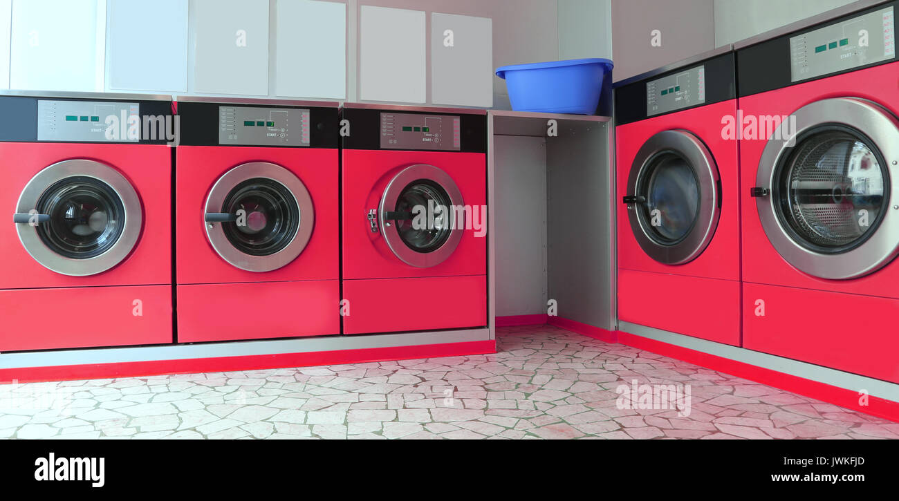 Automatic launderette with five big red washers for washing dirty cloths Stock Photo Alamy