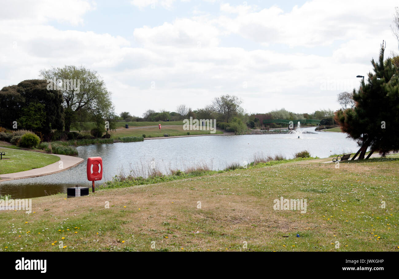 Lake, Lifeguard Ring, Lifebelt, Water Feature, Manmade Landscape, Walkway, Greenery, Trees, Shrubbery, Daisies, Wild Flowers, Nature, Summertime, Path Stock Photo