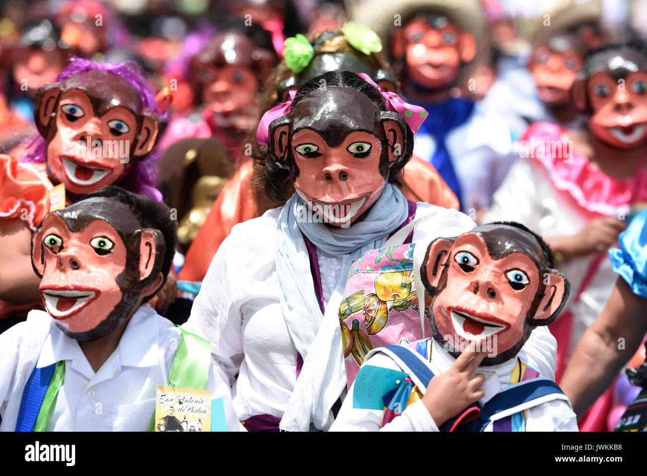 Participants dressed in monkey humouristic costume are walking though the street. Hundreds of people are seen participating during the annual parade of The Crazy Ones, a traditional  parade to celebrate welcome of the Holiday of San Antonio. Stock Photo