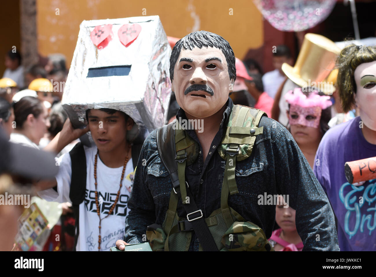 Participants dressed in humouristic costume are walking though the street. Hundreds of people are seen participating during the annual parade of The Crazy Ones, a traditional  parade to celebrate welcome of the Holiday of San Antonio. Stock Photo