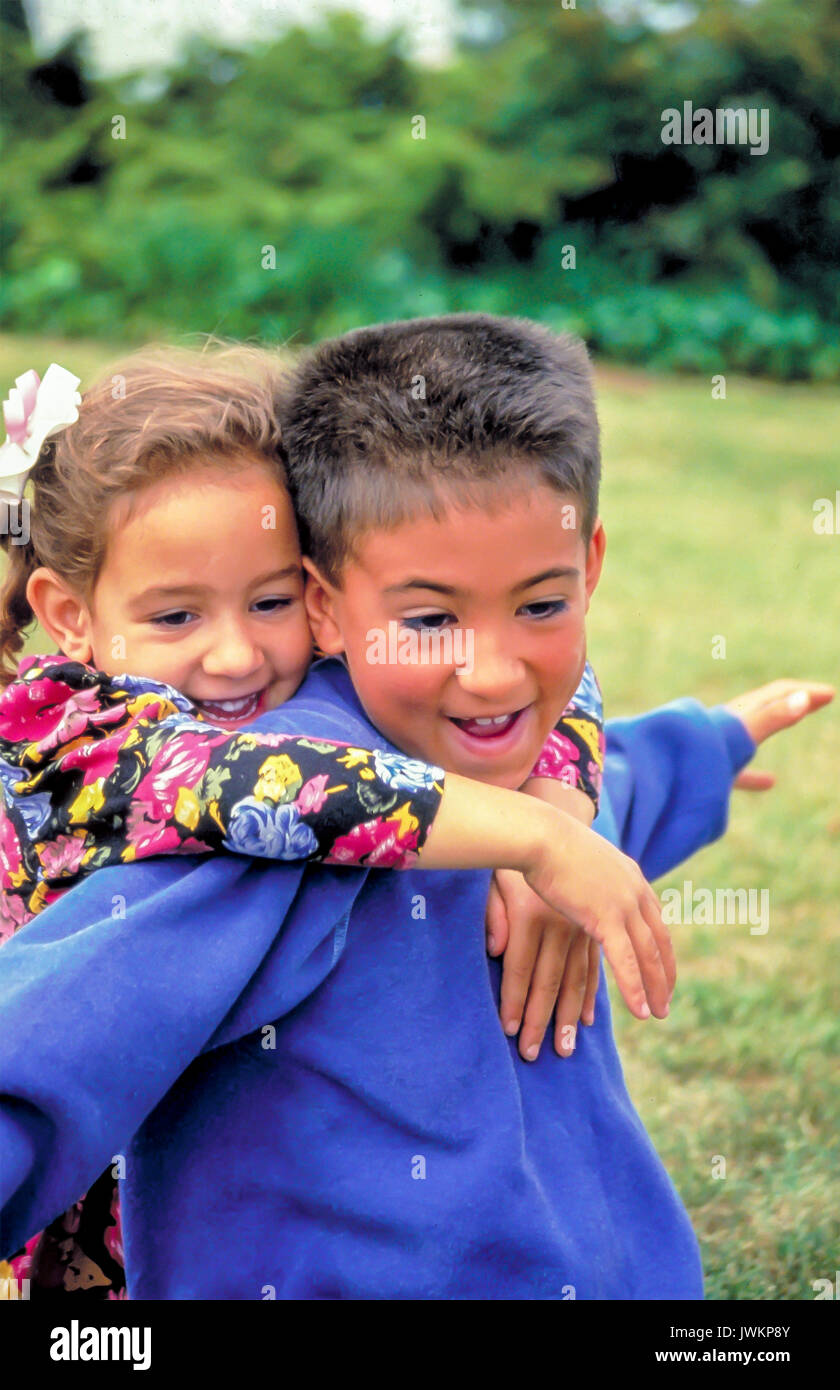 Asian American children having fun brother playing with younger sister Stock Photo