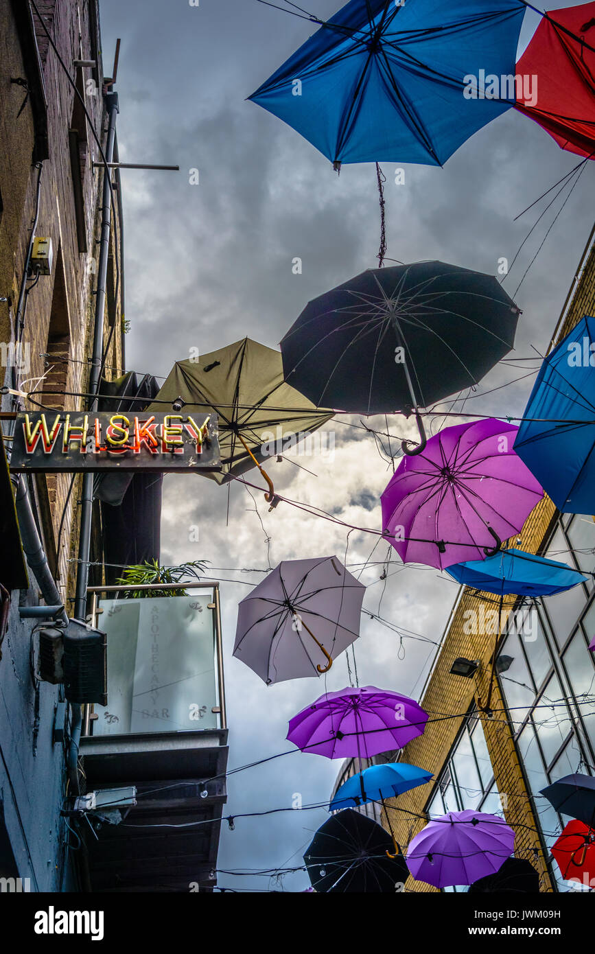 Umbrellas hanging on wires outside of Bar in Dublin Ireland Stock Photo