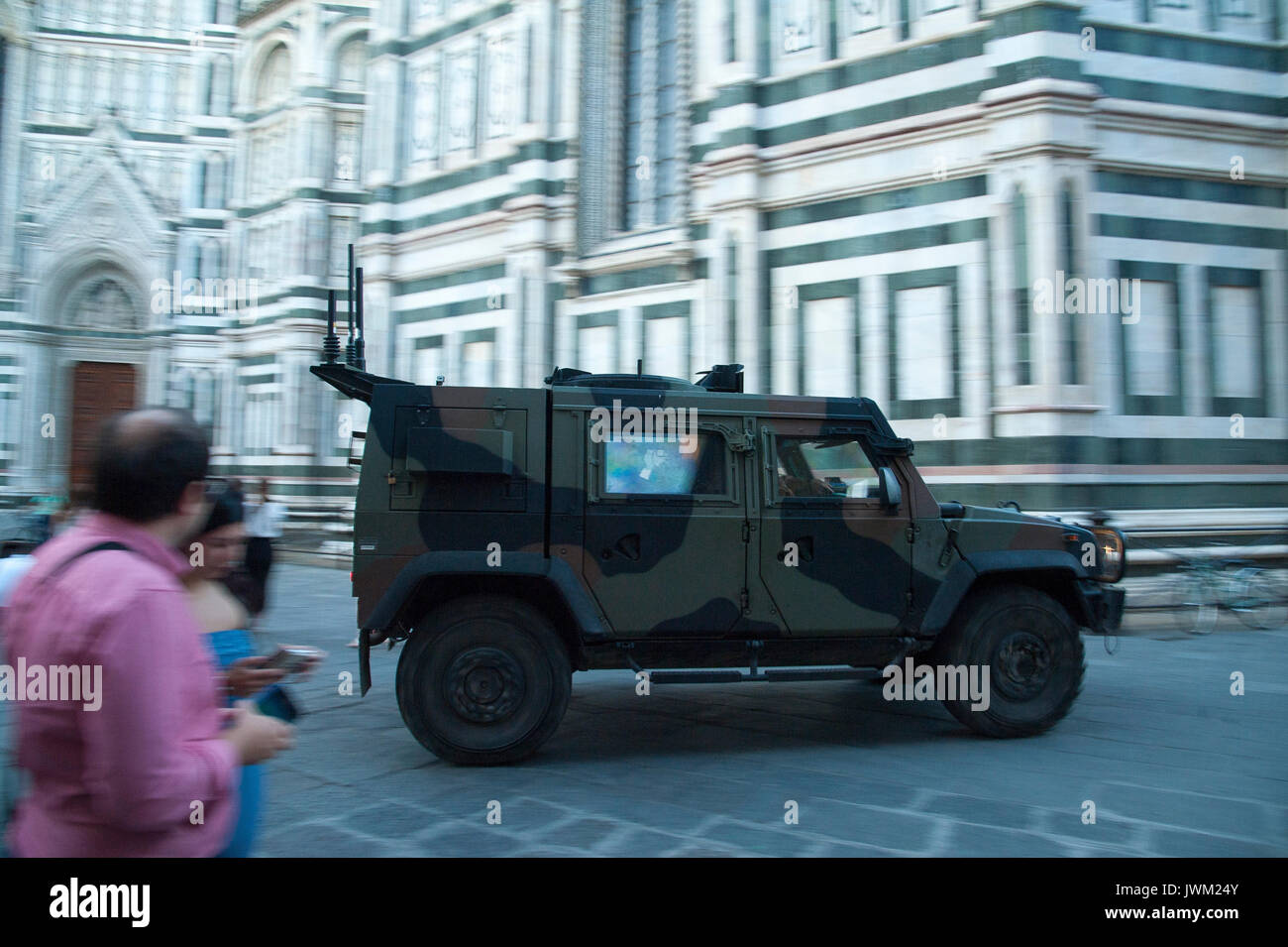 Military car Iveco LMV of during Operazione Strade Sicure in front of Gothic Cattedrale di Santa Maria del Fiore (Cathedral of Saint Mary of the Flowe Stock Photo