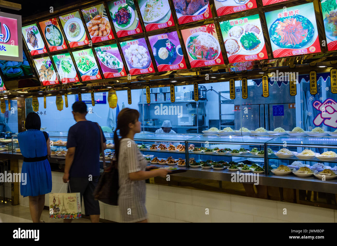 A self service serving hatch is a food court where customers take their selections, put them on their tray and then go to a till to pay. Stock Photo