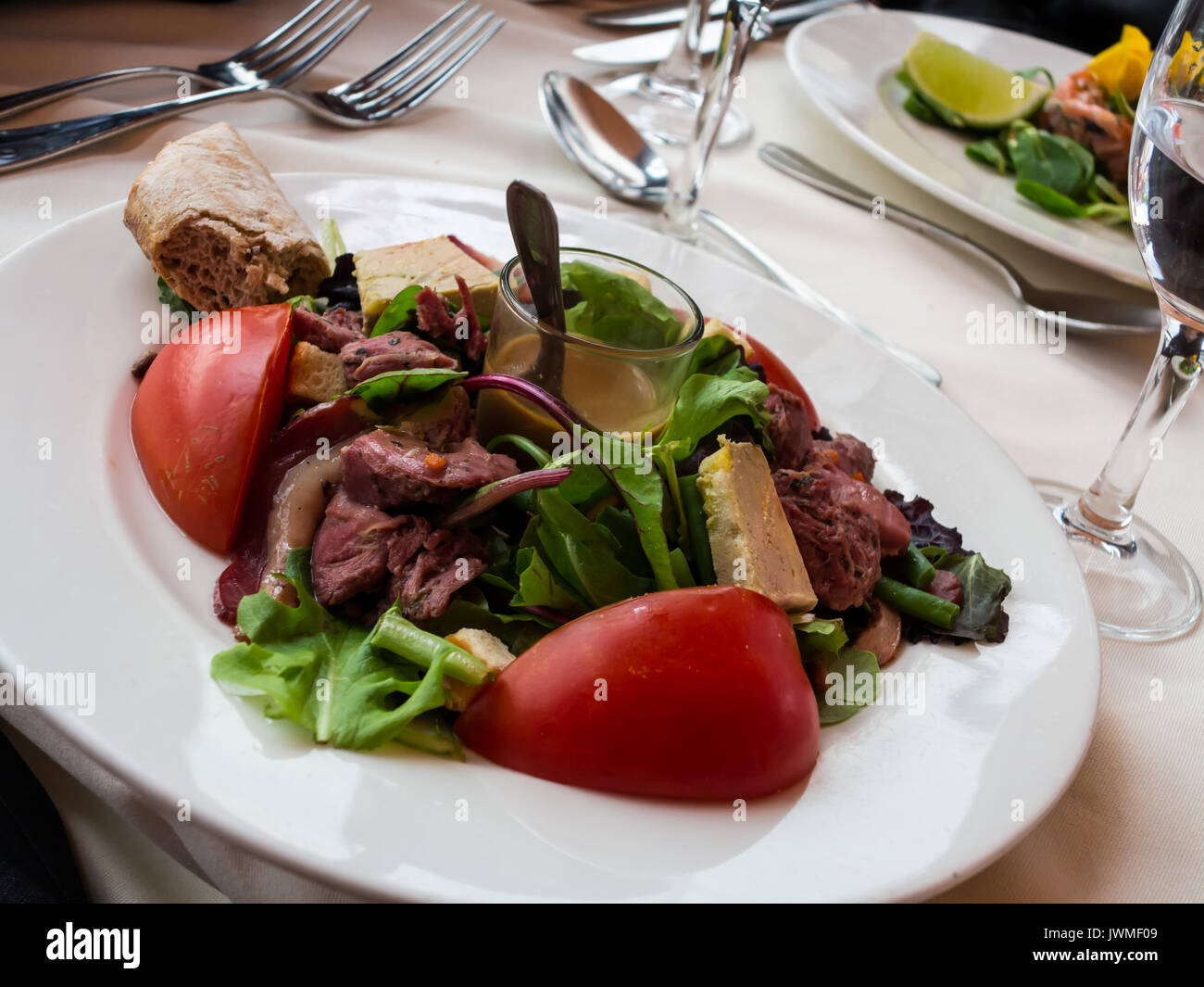 A delicious dinner salad appetizer on a white plate Stock Photo