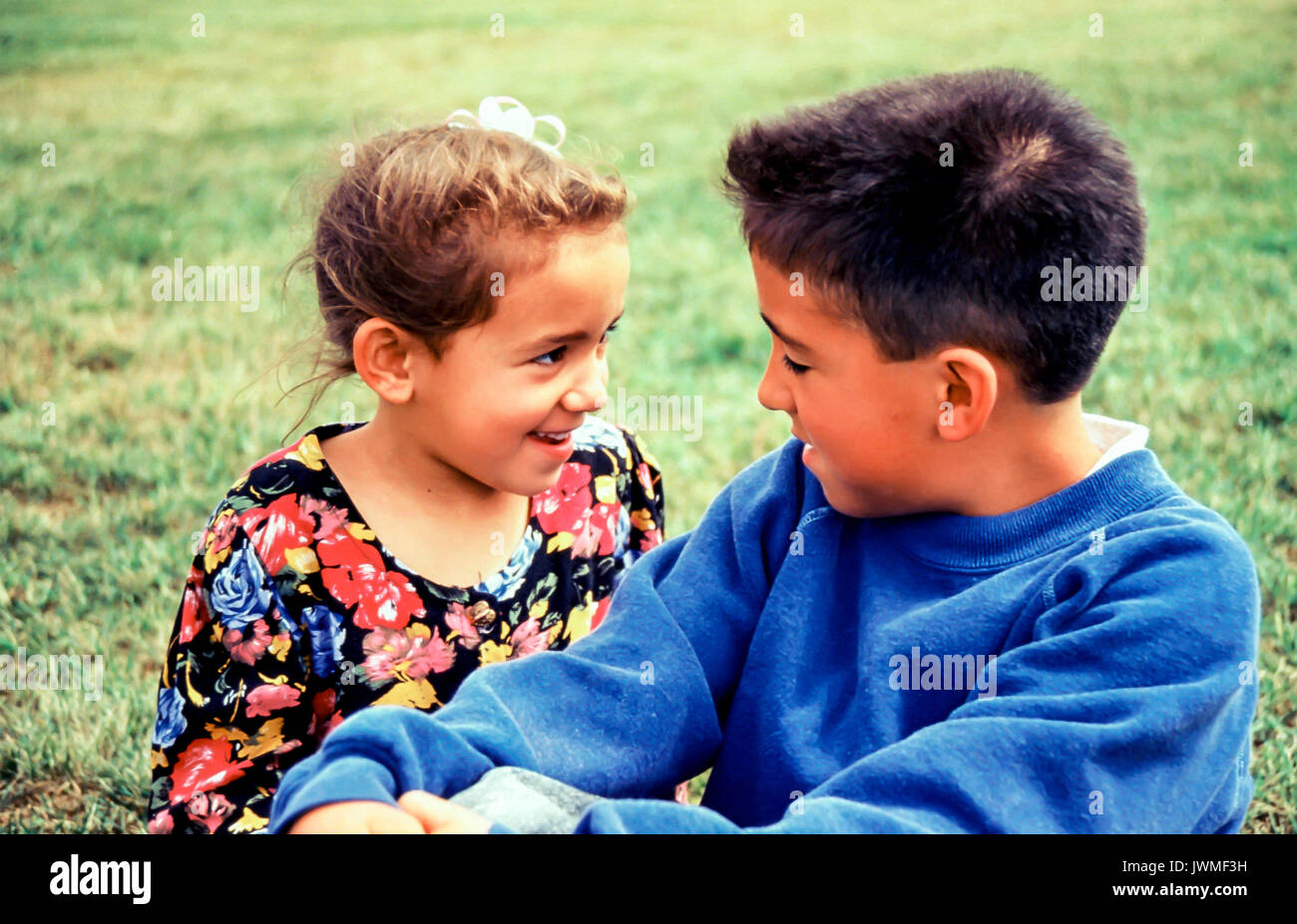 Asian brother 8-9 years old playing together talking with younger sister 5-6 years old Stock Photo