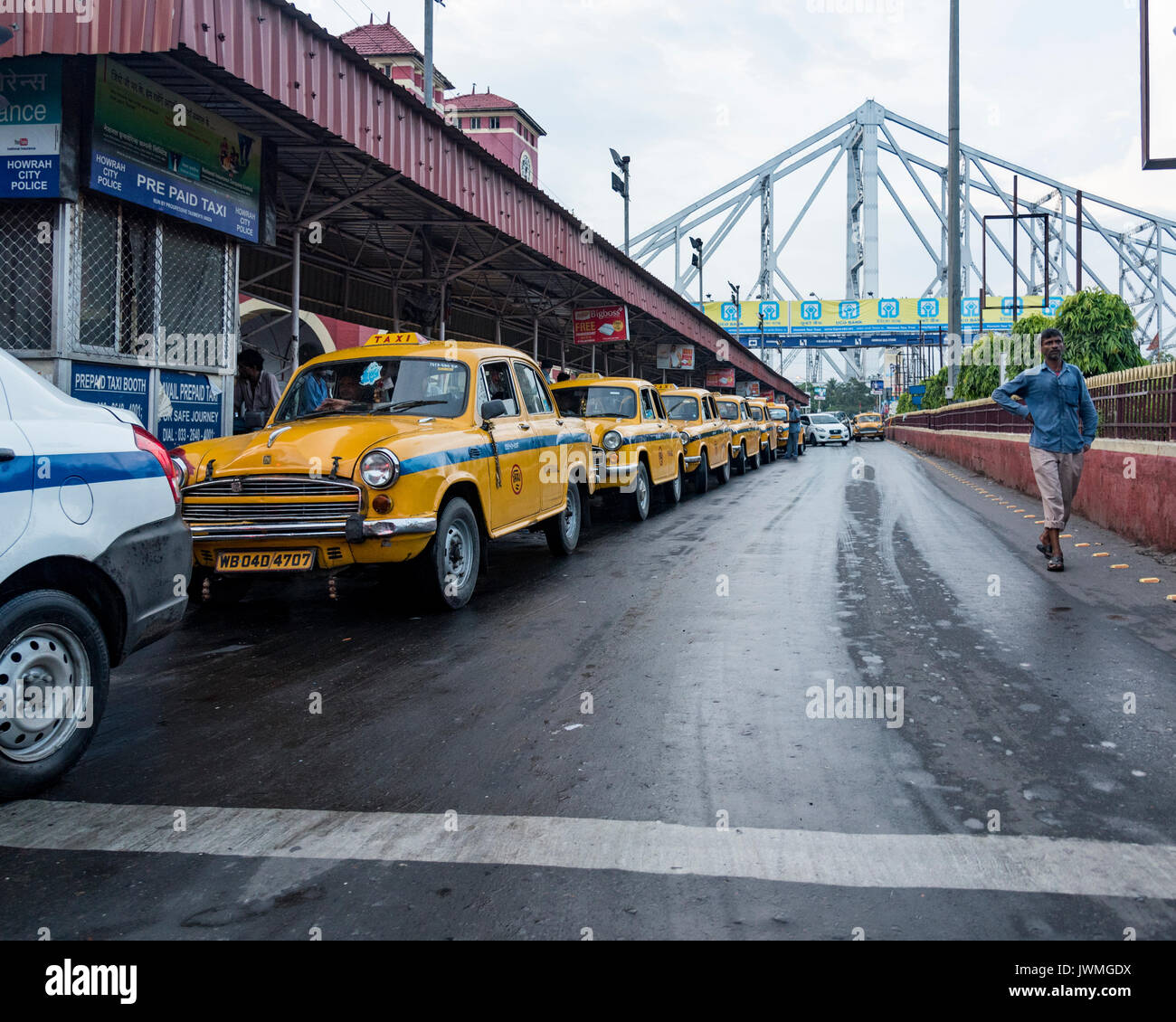 The iconic yellow taxis of Calcutta near Howrah Bridge. Stock Photo