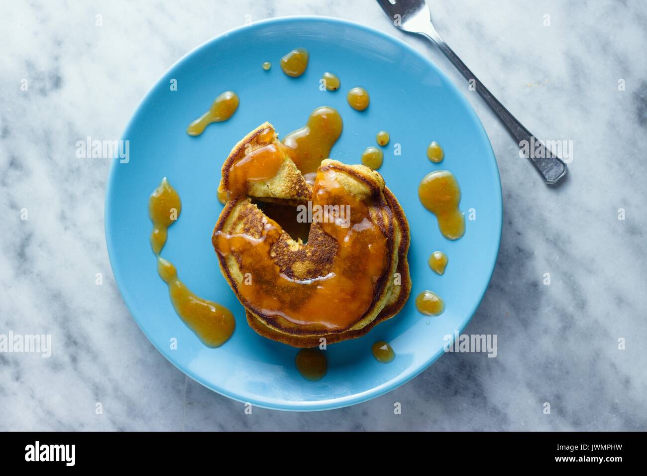Top down view on homemade gluten free pancakes with peach jam Stock Photo