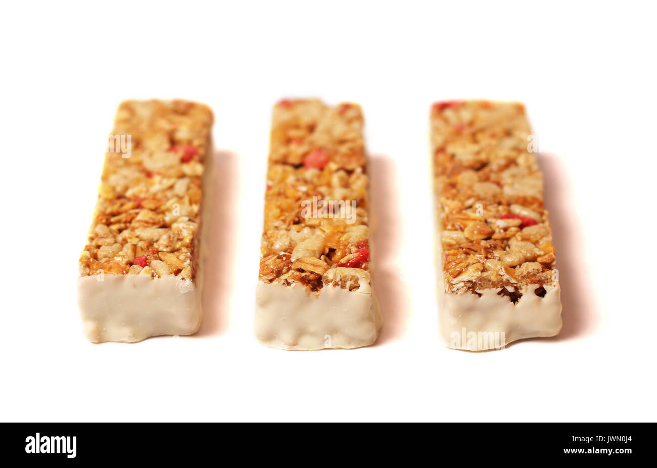 Three fruit and yogurt granola bars on a white background Stock Photo