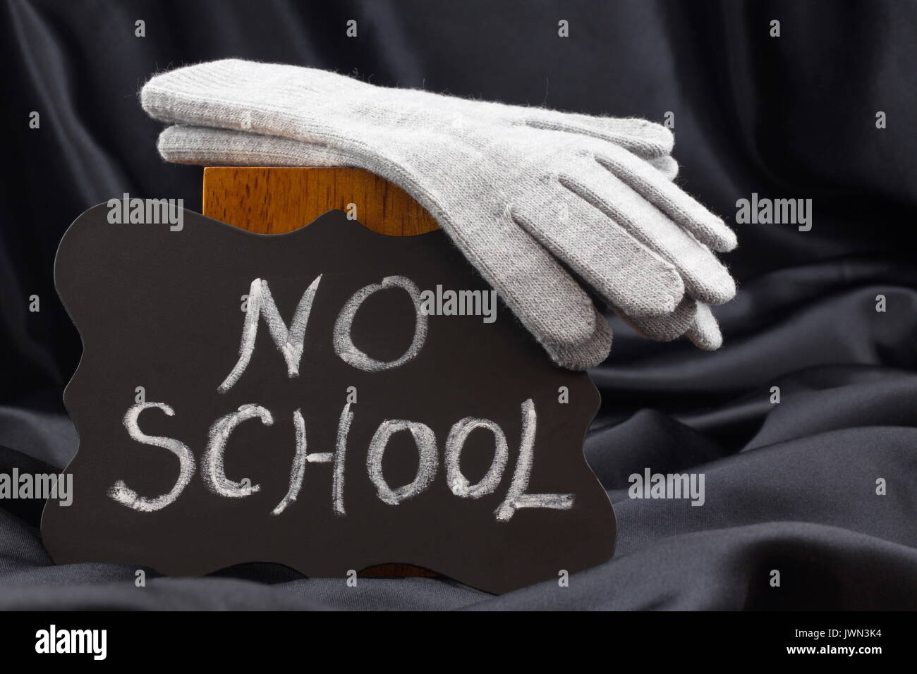 Announcement of NO SCHOOL on chalkboard notifies of winter weather closing. Stock Photo